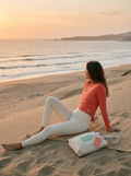 Woman wearing BODA coral Tidal Movement Top and butter leggings on sand dunes
